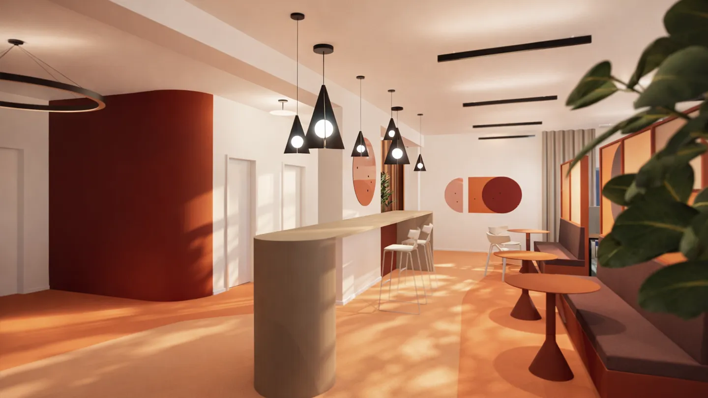 Workcafé mit langem Tresen, Pendelleuchten, Sitzbereichen und warmem Farbkonzept.